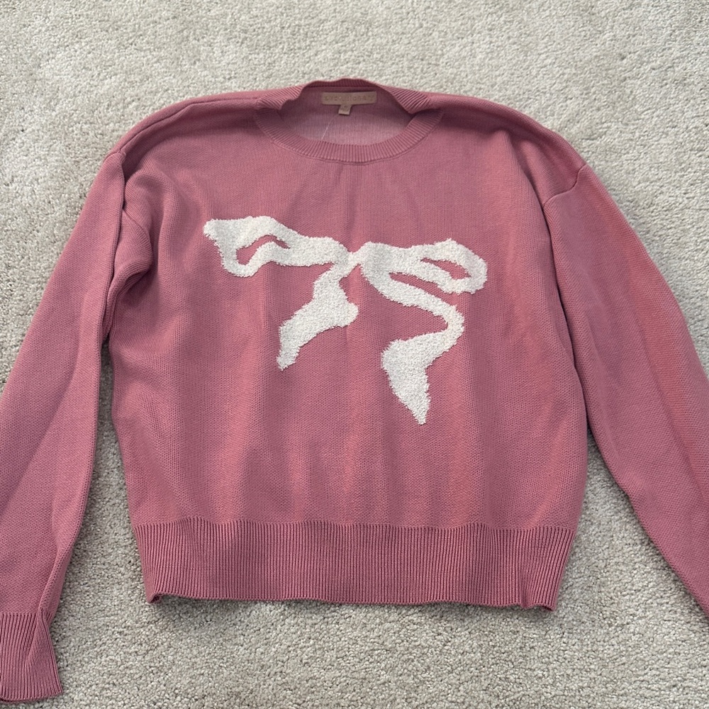 Elegant Pink Sweater with White Bow Accent